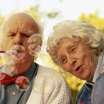 Elderly couple playing with soap bubbles