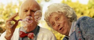 Elderly couple playing with soap bubbles