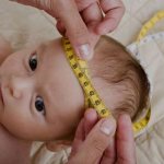 Measuring the head circumference of a baby